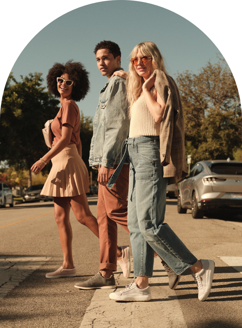 3 people walking across the street wearing Dr. Scholl's shoes