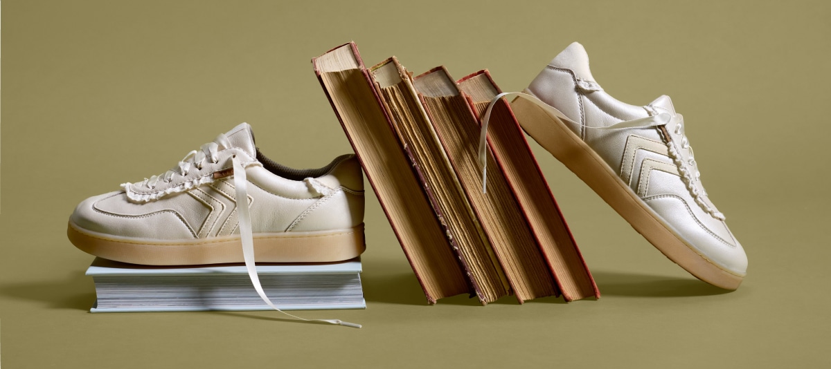 sneakers stacked on books