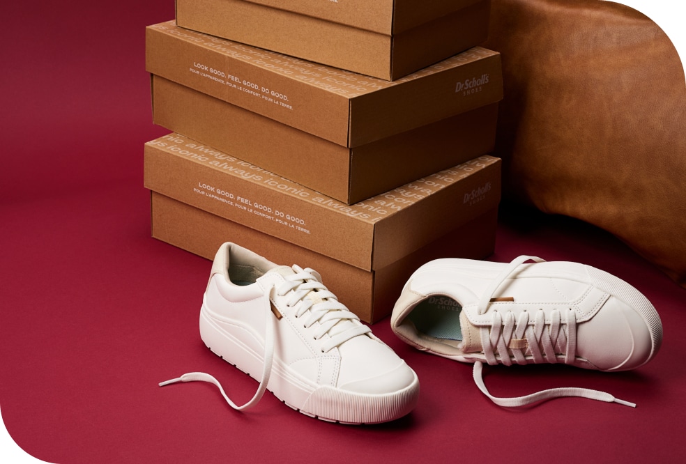 time off sneaker laying next to dr. scholl's shoes boxes