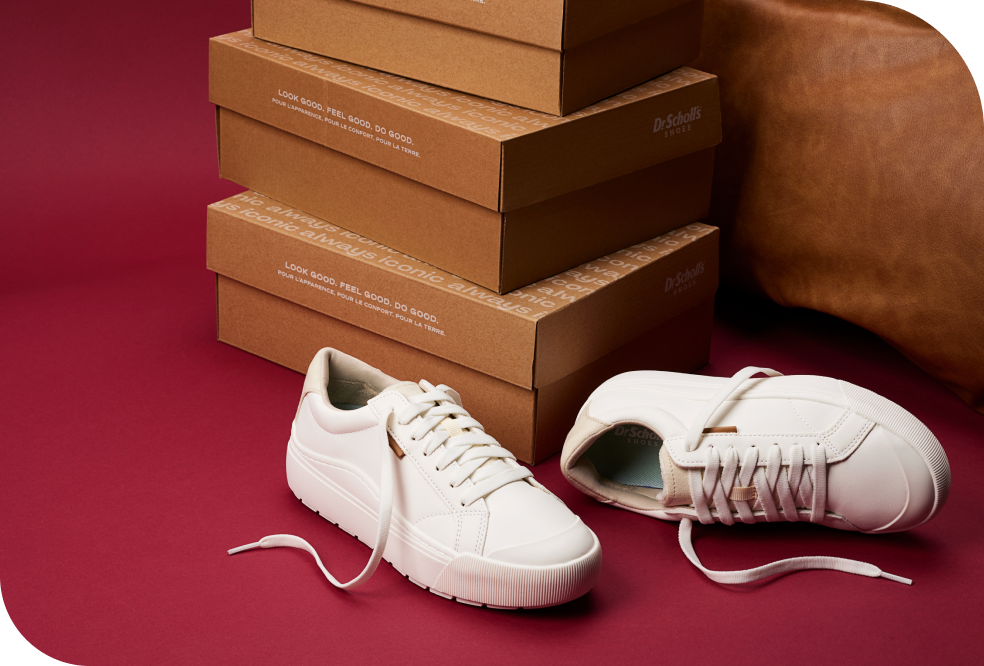 time off sneaker laying next to dr. scholl's shoes boxes