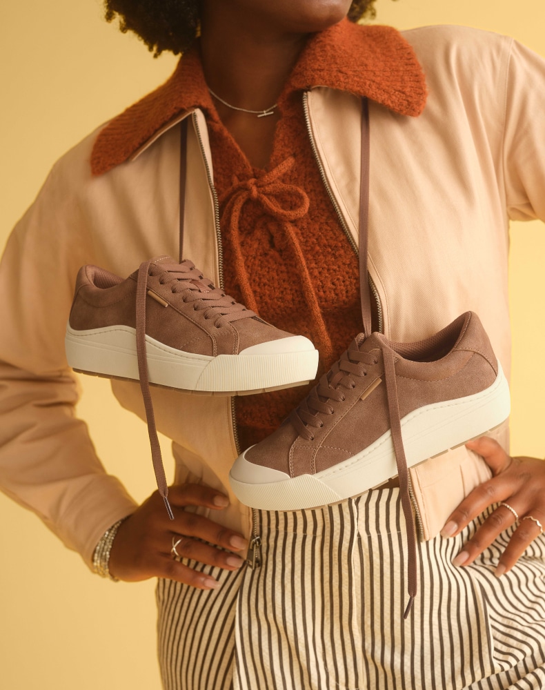 woman posing with the time off sneaker in dark honey
