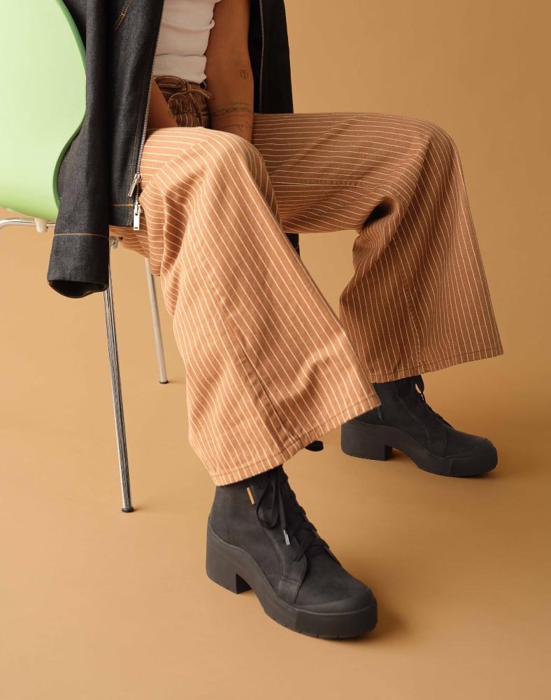 woman wearing the time off up platform ankle boot in black
